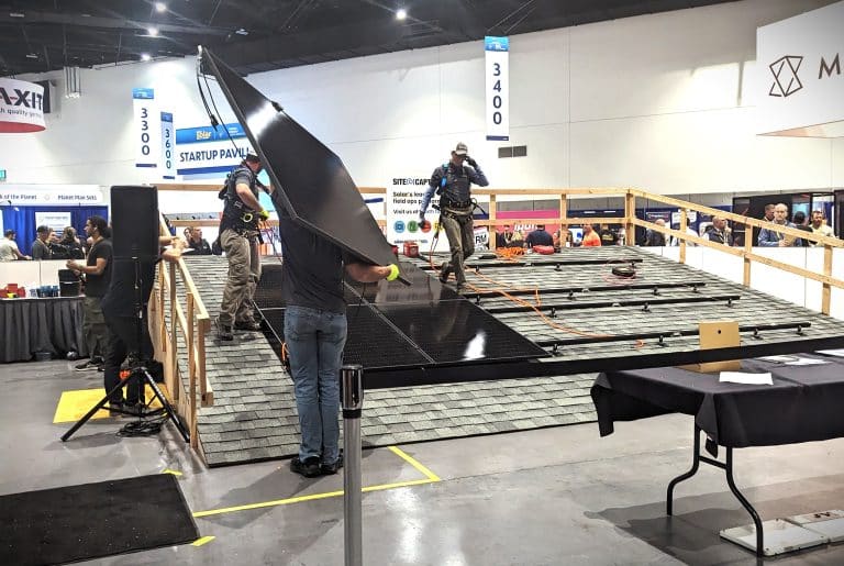 Guy carrying solar panel at InterSolar North America expo